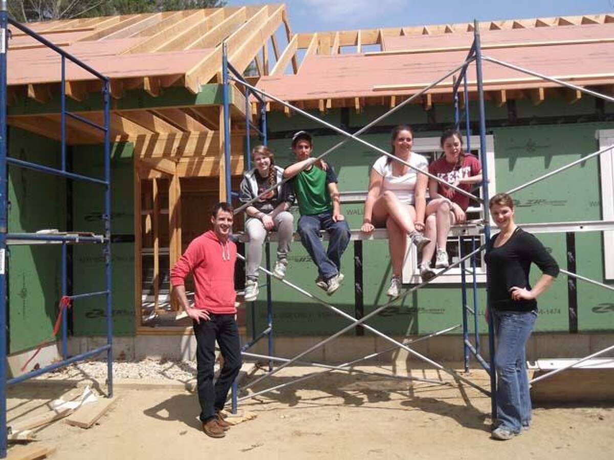Student volunteers work on a Habitat for Humanity house.