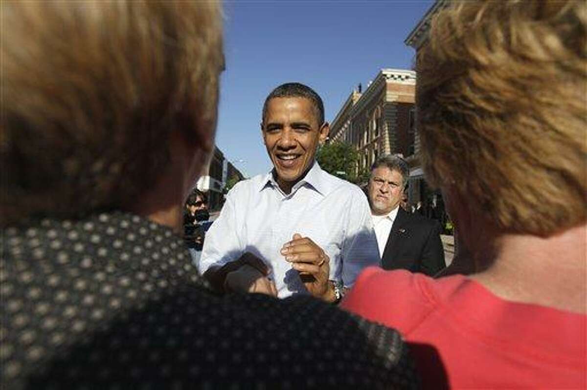 President Barack Obama greets people in Decorah, Iowa, Tuesday, Aug. 16, 2011, during his three-day economic bus tour. (AP Photo/Carolyn Kaster)
