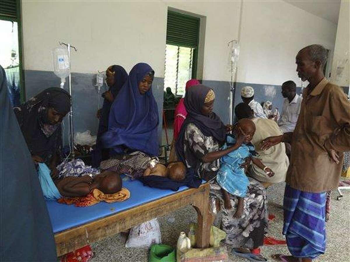 Somalis from southern Somalia wait with their malnourished children in Banadir hospital in Mogadishu, Somalia, Monday, Aug 15, 2011. The World Food Program said Saturday that it is expanding food distribution efforts in famine-ravaged Somalia, where the U.N. has estimated that only 20 percent of people needing aid are able to receive it because an al-Qaida-linked group controls large portions of the country.(AP Photo)