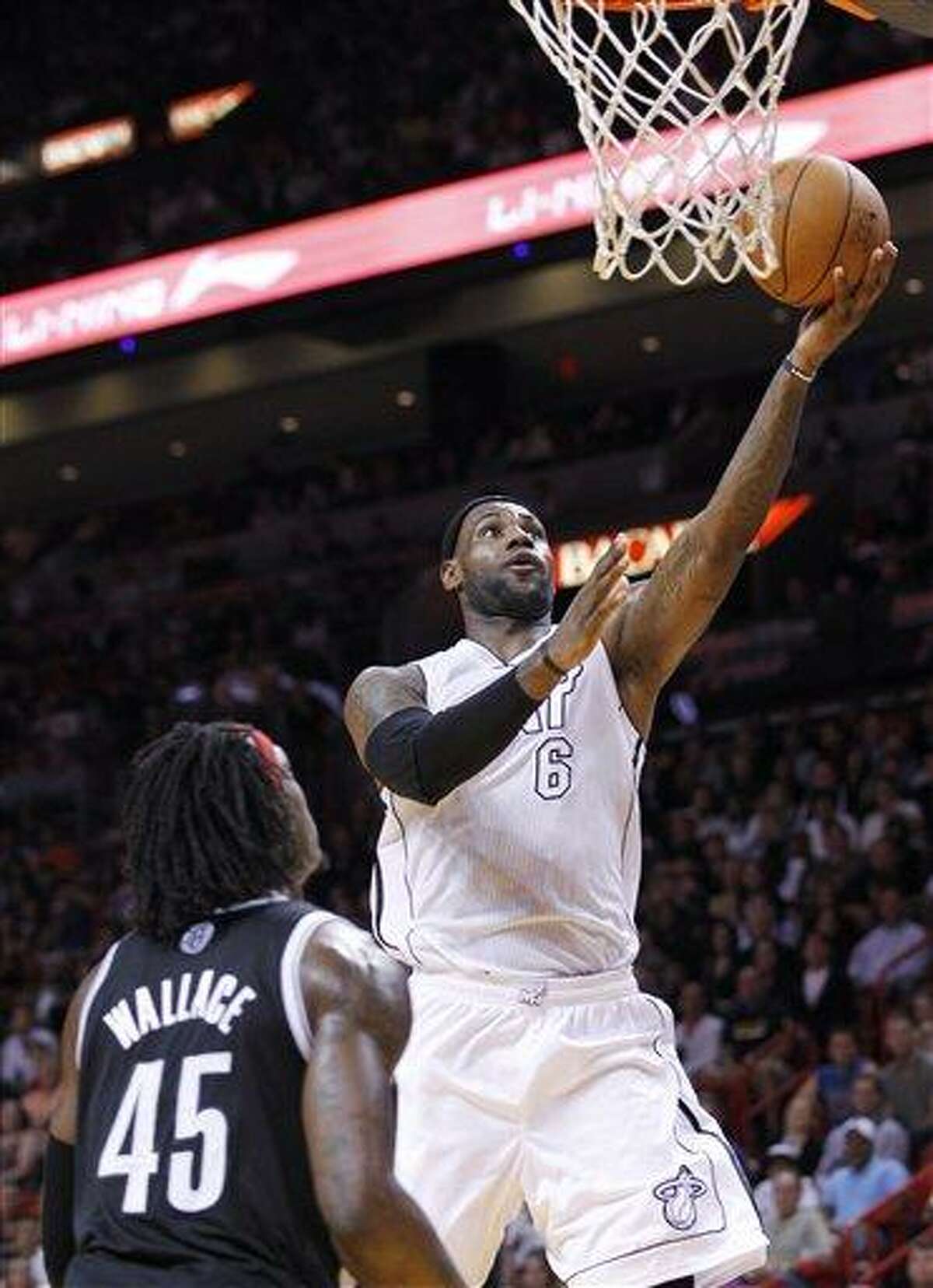 Miami Heat forward LeBron James (6) goes up for a shot against Brooklyn Nets forward Gerald Wallace (45) during the first half of an NBA basketball game, Saturday. AP Photo/Wilfredo Lee