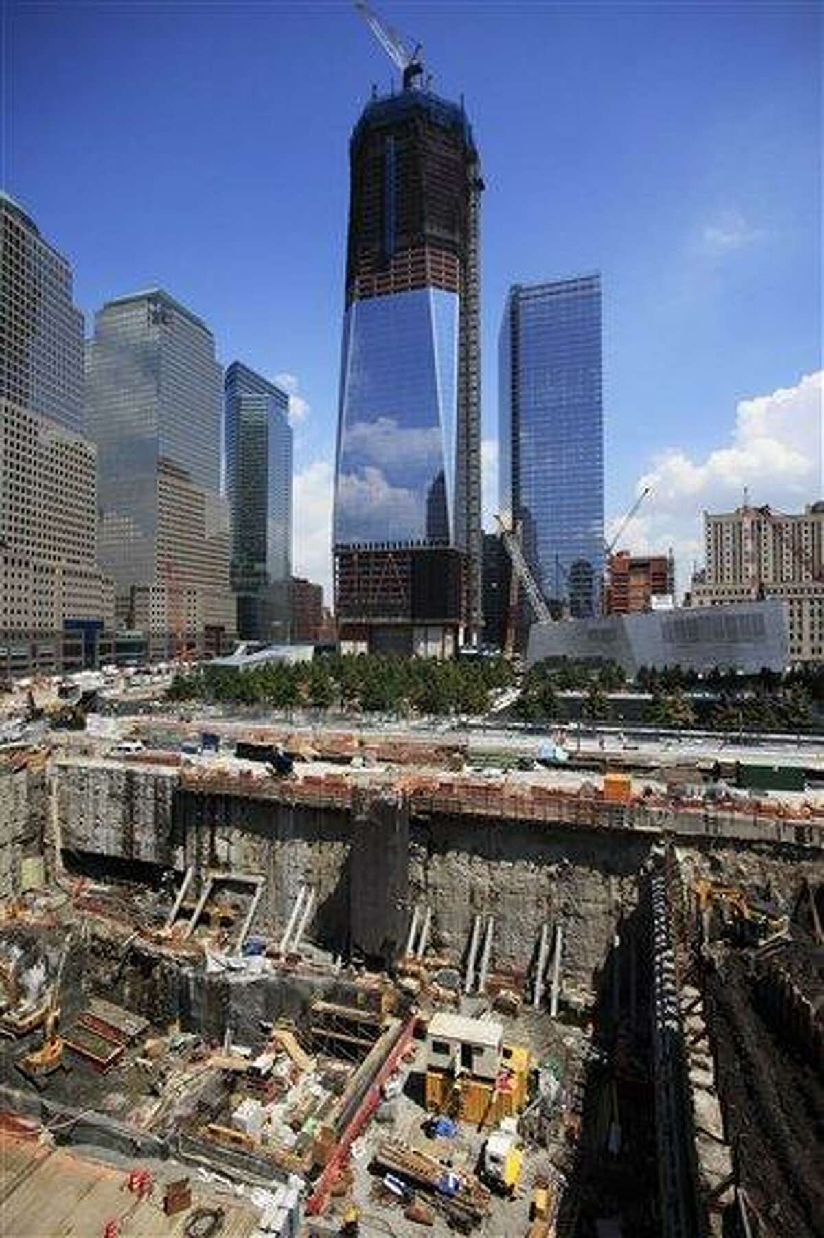 Construction continues on One World Trade Center, top center, and the Vehicle Security Center, lower left, Friday, August 5, 2011 in New York. The tower has reached the 76th floor on the way to 104 floors. (AP Photo/Mark Lennihan)
