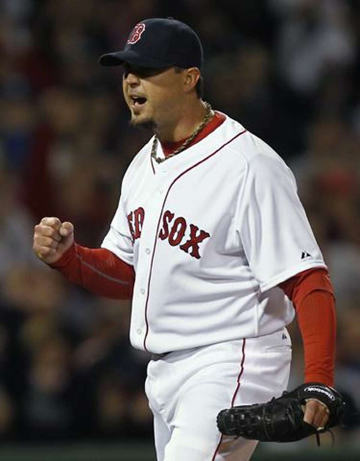 Boston Red Sox starting pitcher Josh Beckett pumps his fist after the Red Sox turned a double play against the New York Yankees during the third inning of a baseball game at Fenway Park in Boston on Sunday, April 10, 2011. (AP Photo/Winslow Townson)