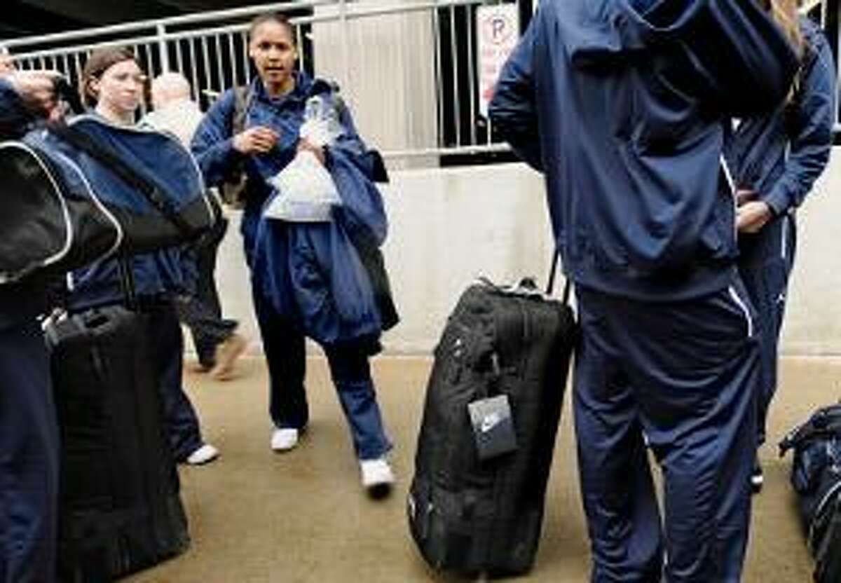 AP Connecticut's Maya Moore boards a bus on campus in Storrs for the airport en route to Indianapolis. Connecticut will face Notre Dame in the Final Four in Indianapolis Sunday.