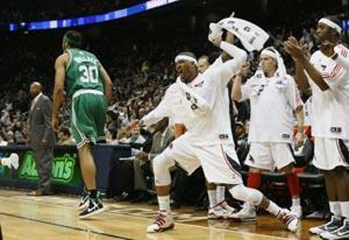 AP Atlanta Hawks' Josh Smith, center, celebrates from the sideline with Mike Bibby, second from right, and Mario West in the second quarter of a game against the Boston Celtics Friday in Atlanta.