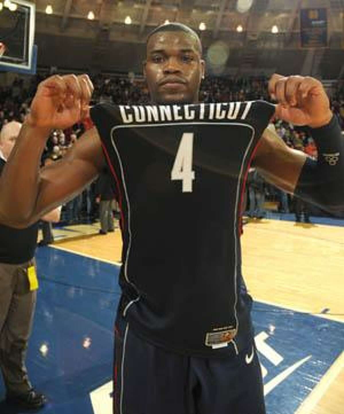 Connecticut guard Jeff Adrien displays his jersey following his team's 69-61 victory over Notre Dame Saturday in South Bend, Ind. Adrien scored 12 points and had 19 rebounds.