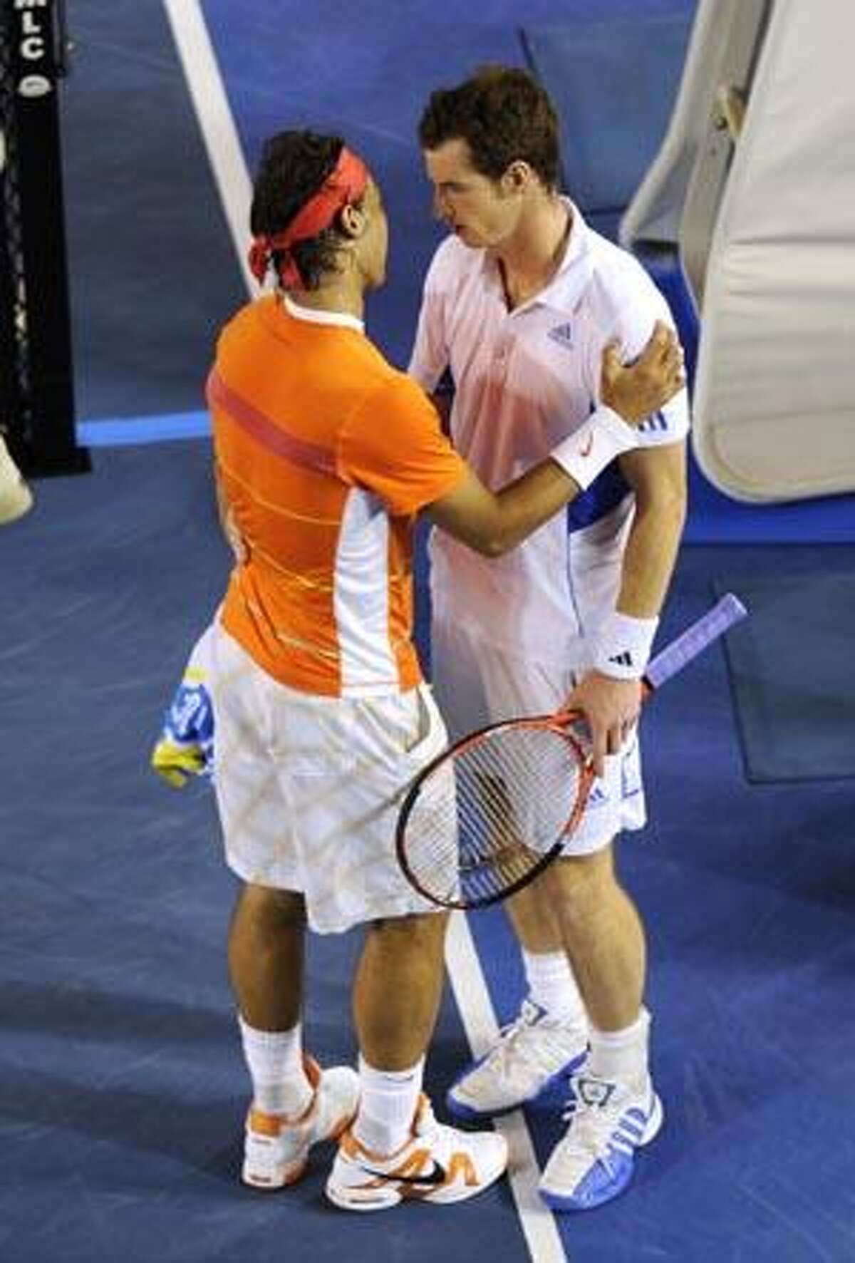 Andy Murray, right, and Rafael Nadal hug each other after Nadal retired injured from their men's singles quarterfinal match Tuesday at the Australian Open in Melbourne, Australia.