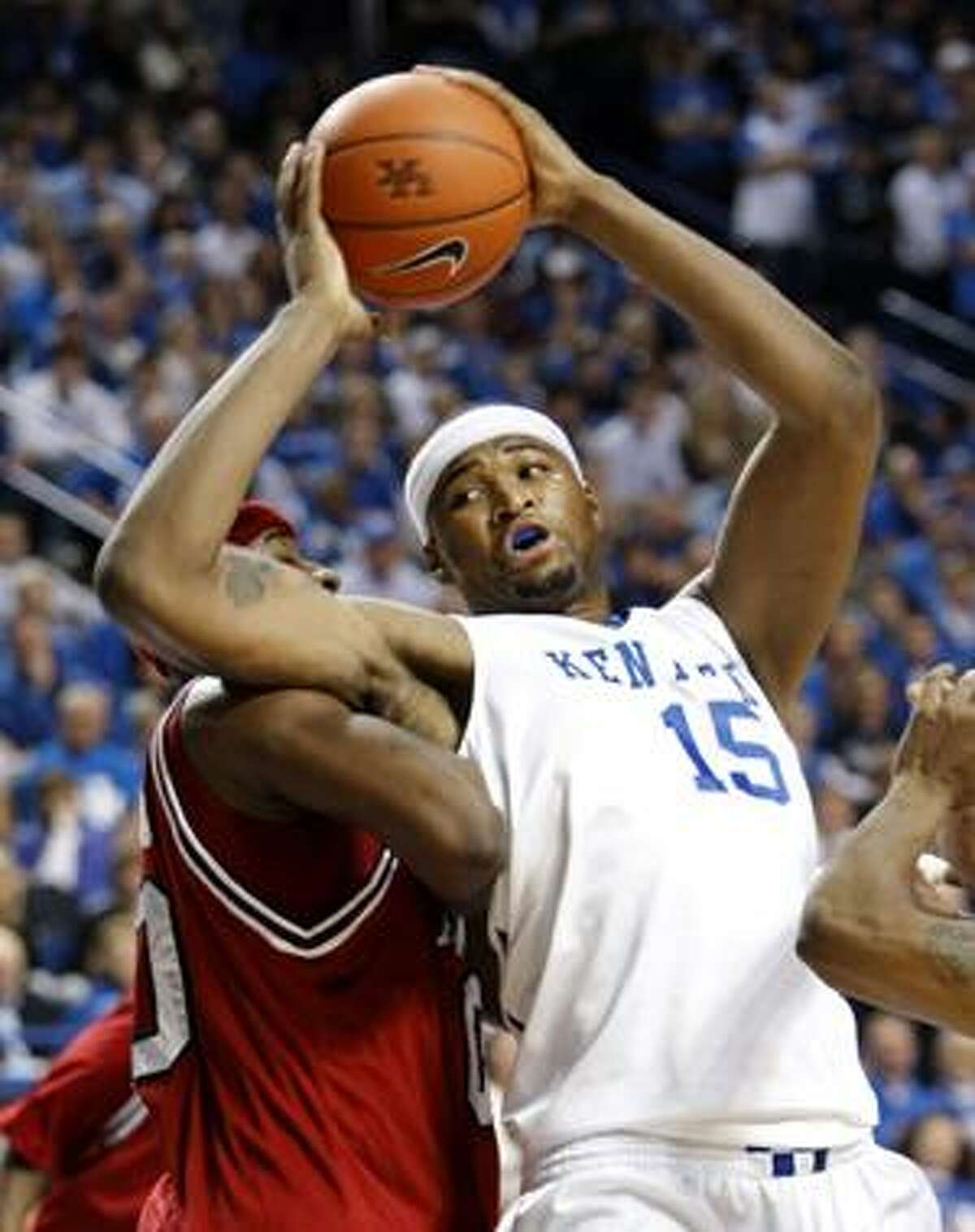 Kentucky's DeMarcus Cousins tries to move around Arkansas's Mike Washington during the first half Saturday in Lexington, Ky.