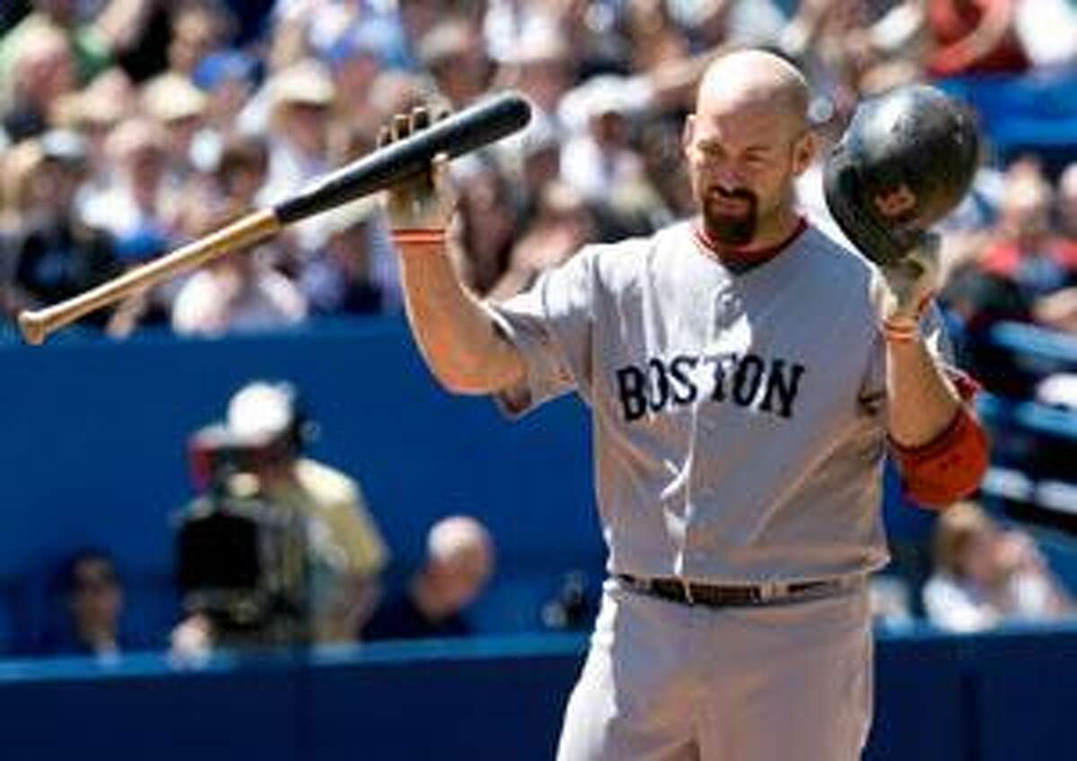 Boston Red Sox third baseman Mike Lowell tosses his bat after he