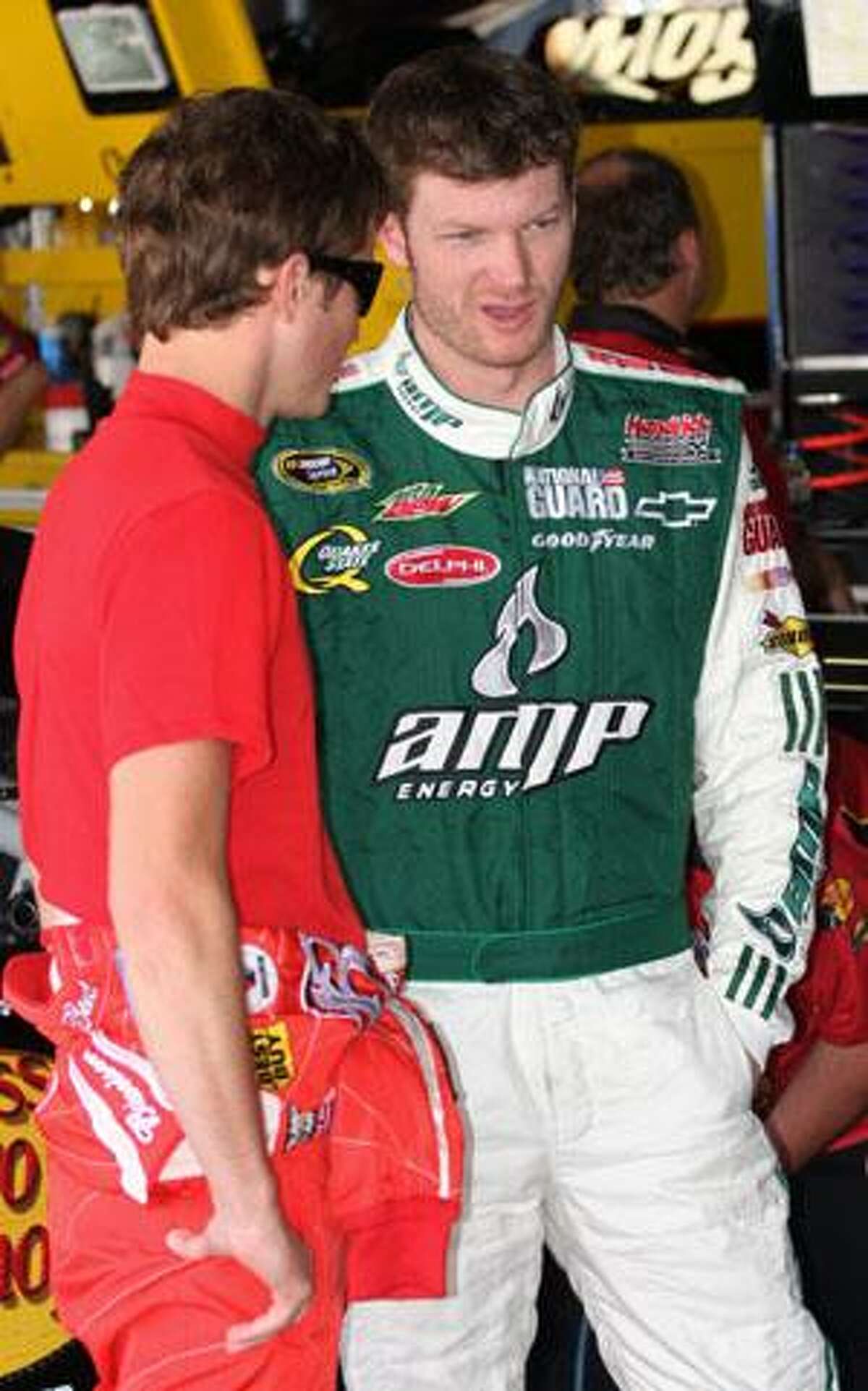 Drivers Kasey Kahne, left, and Dale Earnhardt Jr. talk in the garage area before practicing for the NASCAR Autism Speaks 400 Saturday in Dover, Del. (AP Photo/Russ Hamilton Jr.)