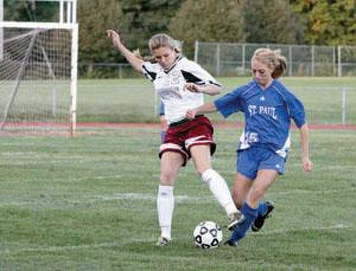 SONJA ZINKE/Register Citizen Torrington's Alyssa Ottis takes the ball from St. Paul's Kelsey Kendrick during Friday's game in Torrington. Purchase a glossy print of this photo and more at www.registercitizen.com.