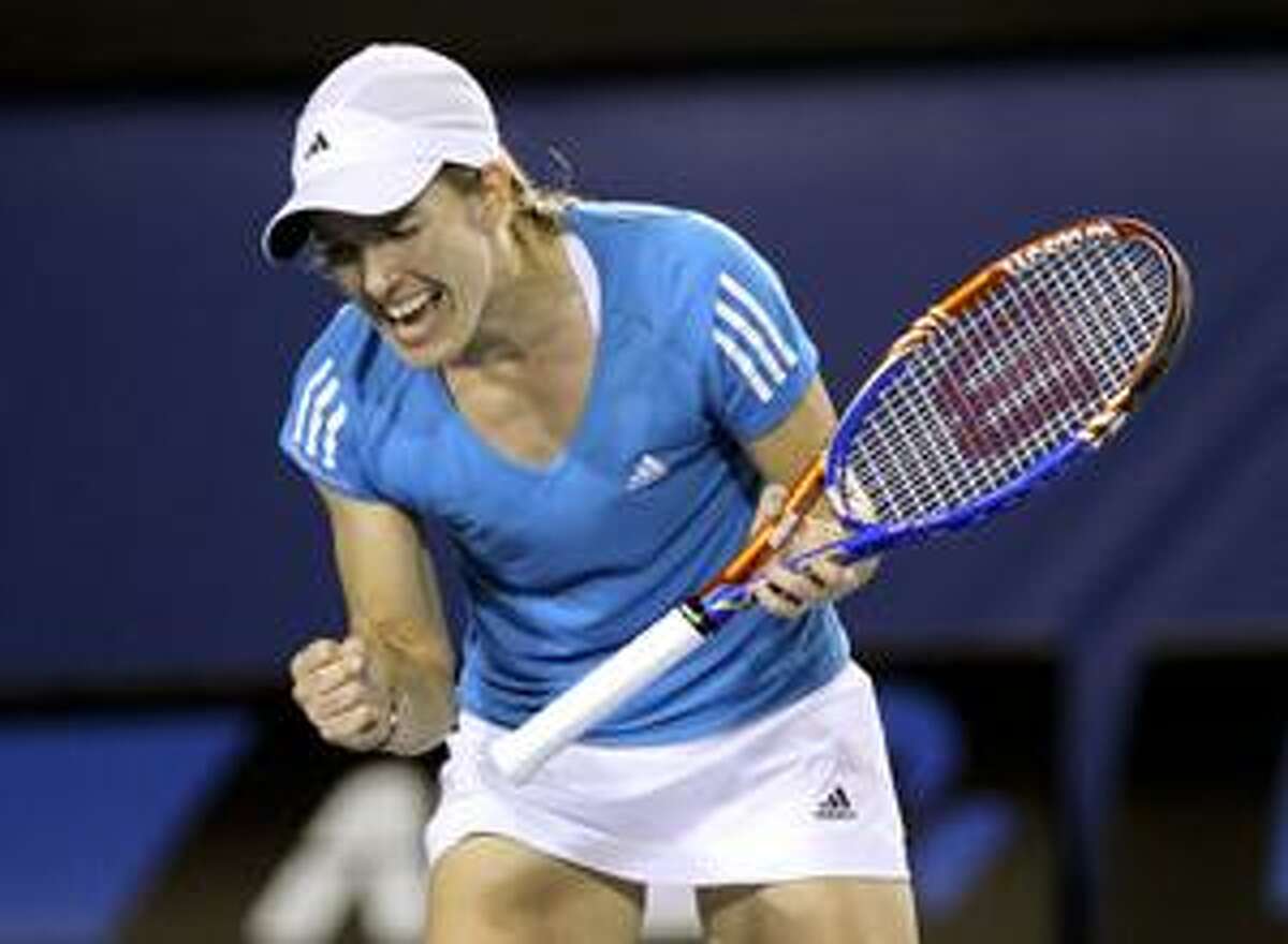AP Justine Henin reacts on her way to beating Elena Dementieva during a women's singles match at the Australian Open tennis championship in Melbourne, Australia, Wednesday.