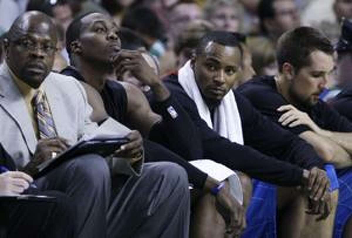 AP Orlando Magic forward Dwight Howard rubs his chin as he sits on the bench with teammates Rashard Lewis and Ryan Anderson, right, in Orlando's 94-71 loss to Boston Saturday. The Celtics lead the series 3-0. Game 4 is tonight in Boston.