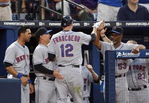 Atlanta Braves Jeff Francoeur (L) high-fives with teammate Brian McCann  after Francoeur's two-run homer in the sixth inning drove in McCann during  play against the visiting New York Mets at Turner Field