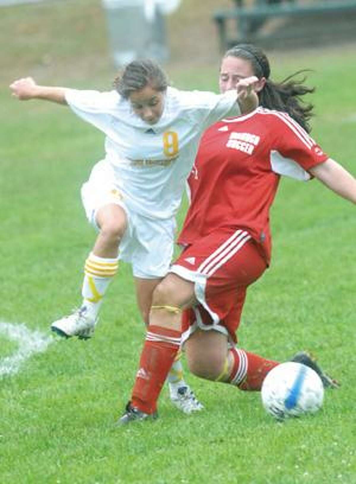 MIC NICOSIA/Register Citizen Gilbert's Courtney Hoxie, left, and Wamogo's Jamie Squiers mix it up during Thursday's game in Winsted. Gilbert won 3-0. Purchase a glossy print of this photo and more at www.registercitizen.com.