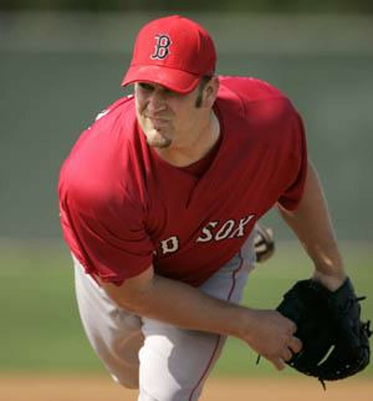 Boston Red Sox hitter Jason Varitek follows through on a bases