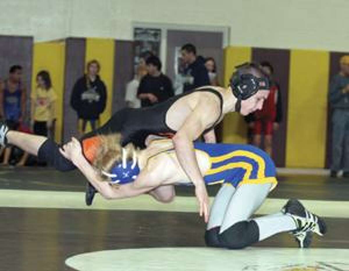 SONJA ZINKE/Register Citizen Gilbert's Alek Smith wrestles with Terryville's DJ Russo during the Berkshire League Tournament in Thomaston Saturday. Smith pinned Russo in the 119 class. Purchase a glossy print of this photo and more at www.registercitizen.com.