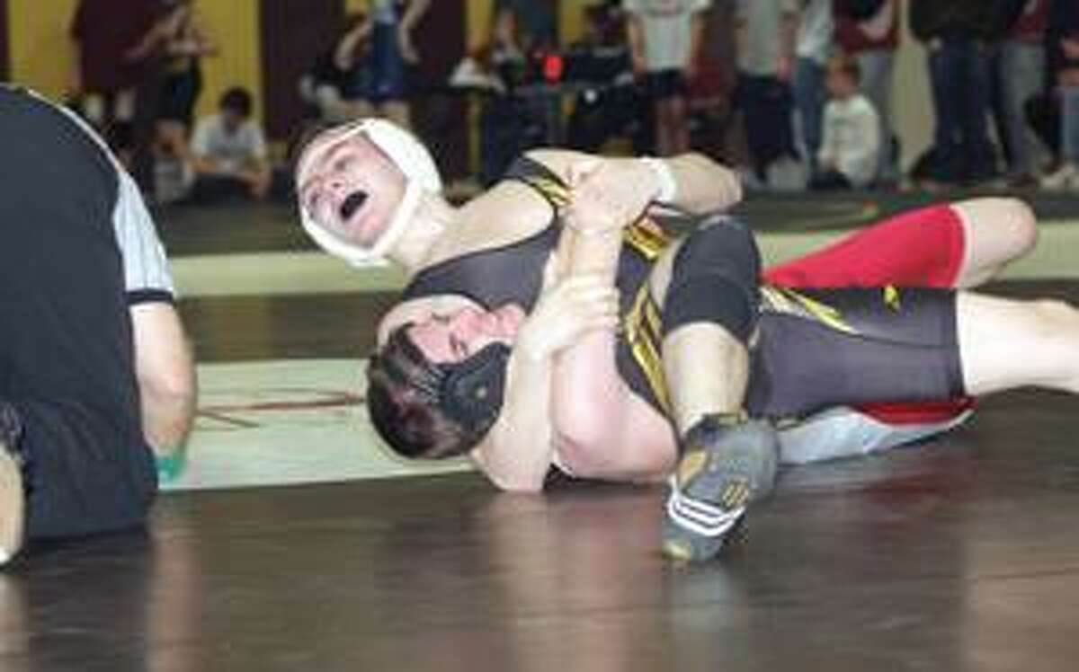 SONJA ZINKE/Register Citizen Thomaston's Tyler Foley pins Northwestern's Will Kelsey in the 112-pound weight class during Saturday's Berkshire League Tournament in Thomaston. Purchase a glossy print of this photo and more at www.registercitizen.com.
