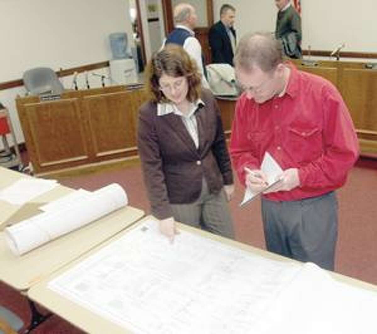 SONJA ZINKE/Register CitizenLorel H. Purcell, Preconstruction Manager for O&G Industries, Inc. talks with Gene Farley of the Torrington Lumber Company during the walk through at City Hall Thursday. Purchase a glossy print of this photo and more at www.registercitizen.com