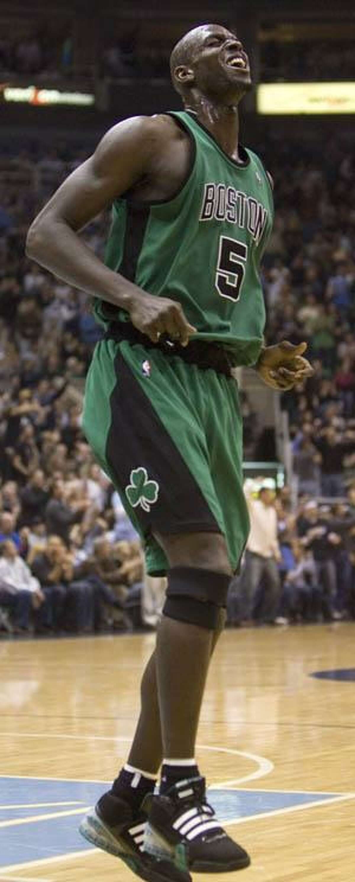 Boston Celtics forward Kevin Garnett (5) hops in pain during the second quarter against the Utah Jazz Thursday night in Salt Lake City.