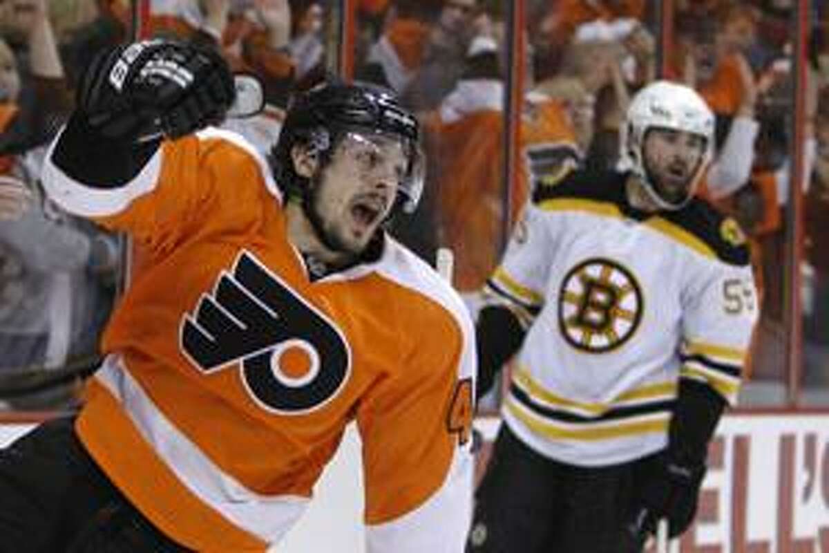 Philadelphia Flyers' Danny Briere, left, celebrates after his goal as Boston Bruins' Johnny Boychuk looks on in the second period of Game 6 of a second-round NHL playoff hockey series, Wednesday, May 12, 2010, in Philadelphia. (AP Photo/Matt Slocum)