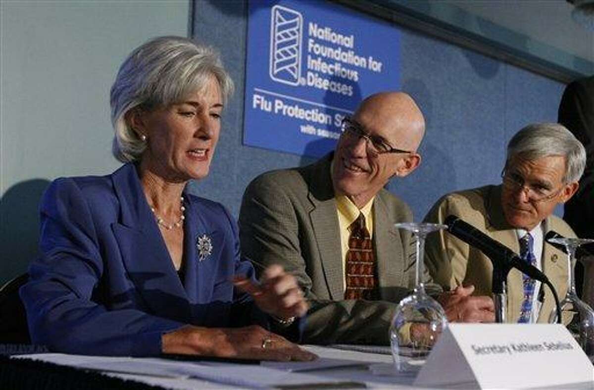 FILE - In this Sept. 10, 2009, file photo, Health and Human Services Secretary Kathleen Sebelius, left, talks with Mayo Clinic Vaccine Research Group Director Dr. Gregory A. Poland , center, and American Academy of Pediatrics President Dr. David T. Tayloe, at the National Press Club in Washington. The government is starting an unprecedented system to track possible side effects as mass flu vaccinations begin next month. (AP Photo/Luis M. Alvarez)