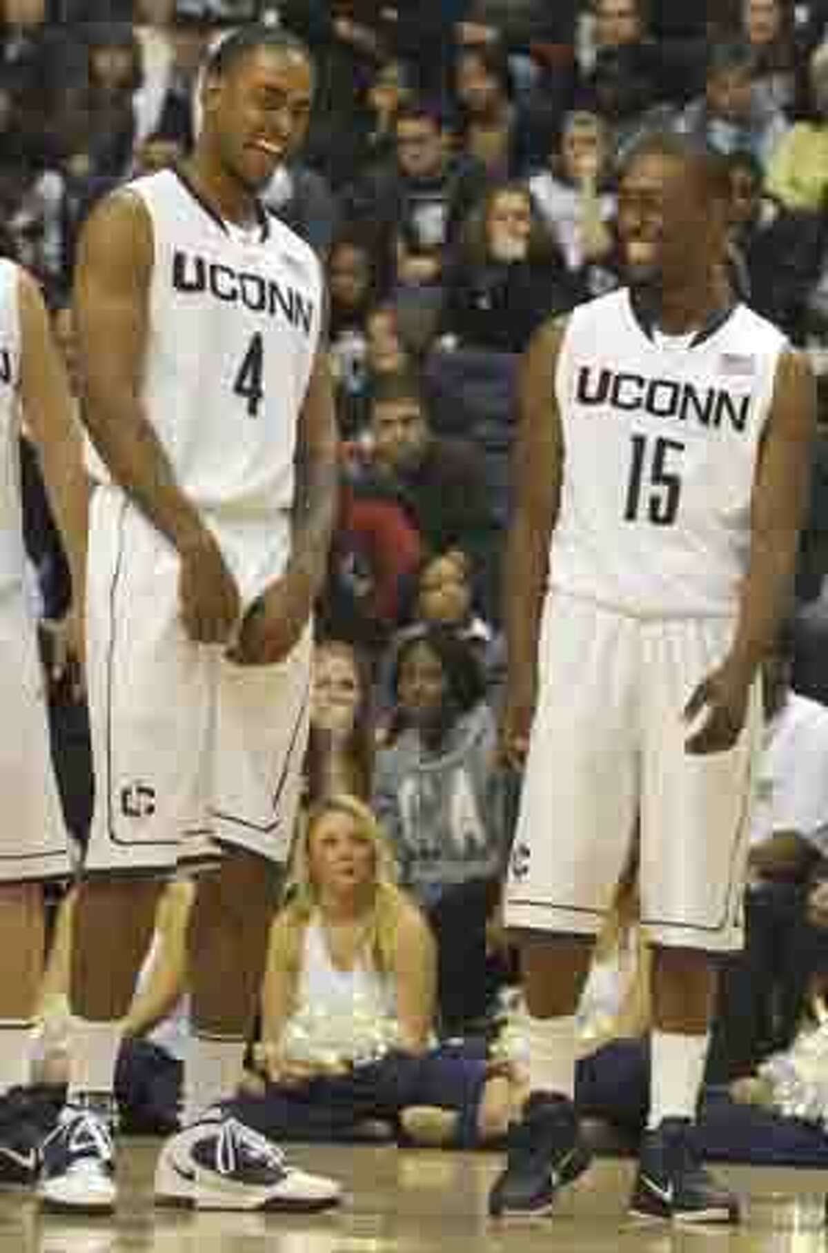 Connecticut's Jamal Coombs-McDaniel, left, and Kemba Walker, right, react during a "Simon Says" competition at the First Night NCAA college basketball exhibition, in Storrs, Conn., Friday, Oct. 15, 2010. (AP Photo/Jessica Hill)