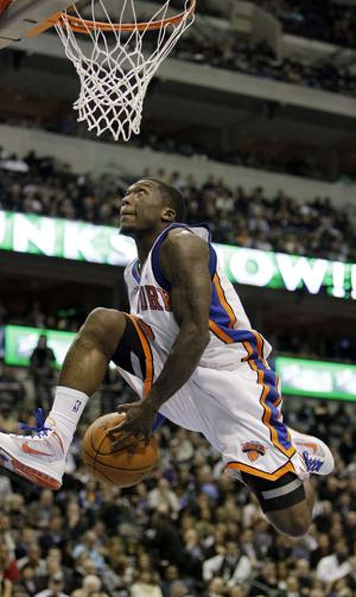 AP New York Knicks guard Nate Robinson eyes the basket during the slam dunk contest at All-Star Saturday Night in Dallas. Robinson captured his third straight slam dunk title.
