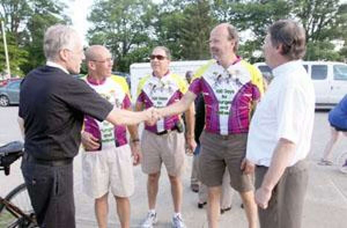 SONJA ZINKE/Register CitizenSt. Paul's Lutheran Church's Pastor Paul Sinnott, left and Pastor Mike Millum greet the riders for the Tour De Rev Friday at St. Paul's Lutheran Church in Torrington. From left, Fred Soltow, Adam Link and Roger Munro. The Reverends are on a 13,000 mile journey across the country to raise awareness and funds for hunger and wellness. Purchase a glossy print of this photo and more at www.registercitizen.com