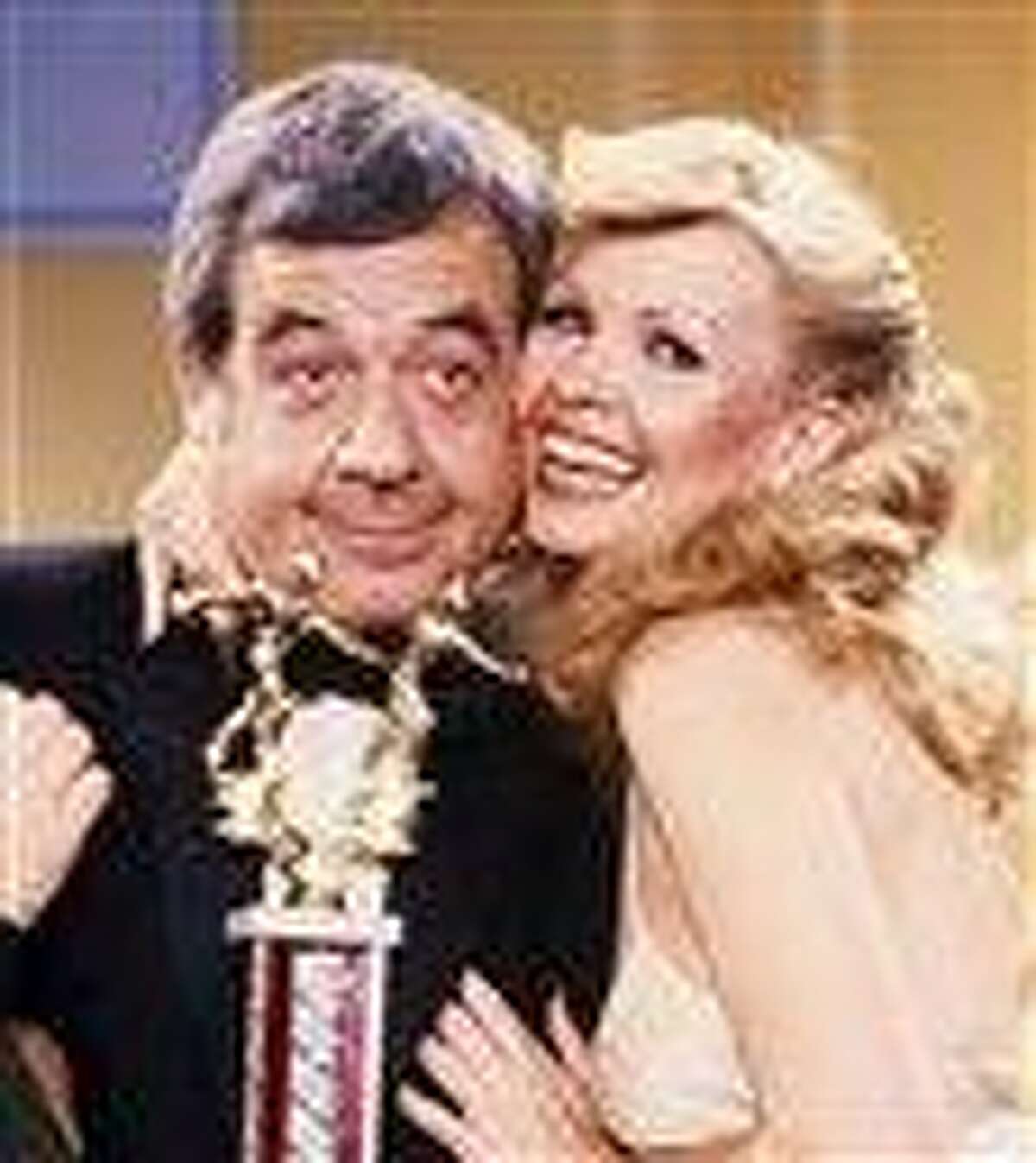 FILE - In this March 21, 1981 file photo, actorTom Bosley, who plays Mr. Cunningham on the series "Happy Days," embraces his real-life wife Patricia Carr Bosley, during the filming of a scene of "Happy Days," where she guest-starred. Bosley, the patient, understanding father on television's long-running "Happy Days," died of heart failure early Tuesday, Oct. 19, 2010, at a hospital near his home in Palm Springs, Calif. He was 83. (AP Photo/Reed Saxon, file)