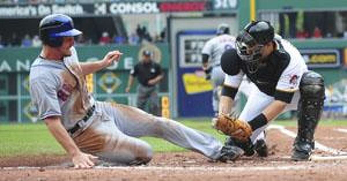 New York Mets' Daniel Murphy, left, is tagged out at the plate by Pittsburgh Pirates catcher Jason Jaramillo during the second inning Thursday in Pittsburgh. Murphy tried to score from third when Omir Santos hit into a fielder's choice.