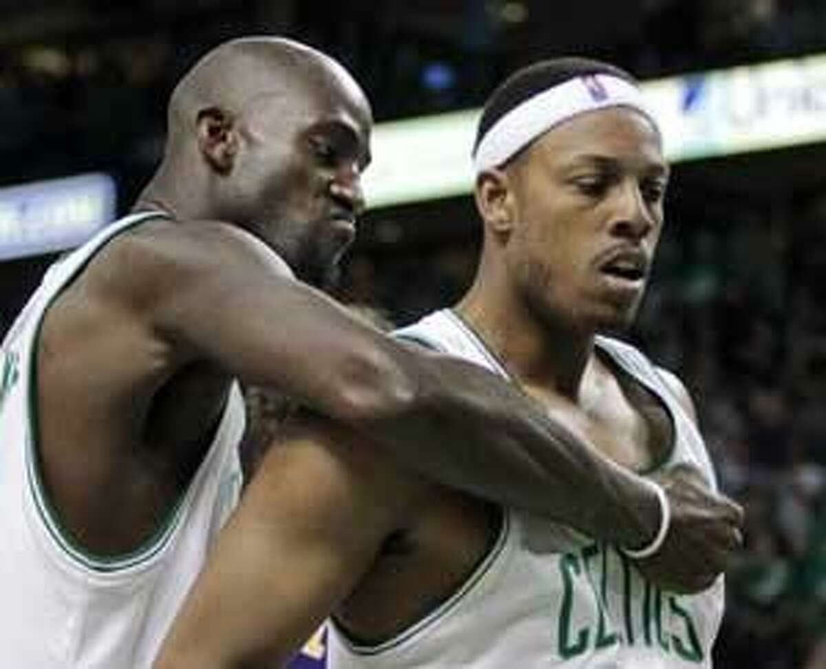 Boston Celtics forward Kevin Garnett, left, pounds the chest of teammate Paul Pierce during the fourth quarter in Game 4 of the NBA basketball finals against the Los Angeles Lakers on Thursday, June 10, 2010, in Boston. The Celtics won 96-89 to even the series. (AP Photo/Michael Dwyer)