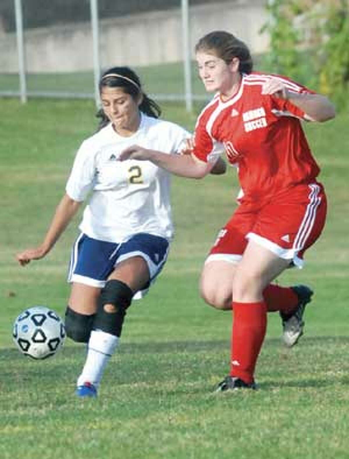 Wolcott Tech's Julia Lajoie, left, and Wamogo's Morgan Grambo battle for possession during Tuesday's Berkshire League game in Torrington.