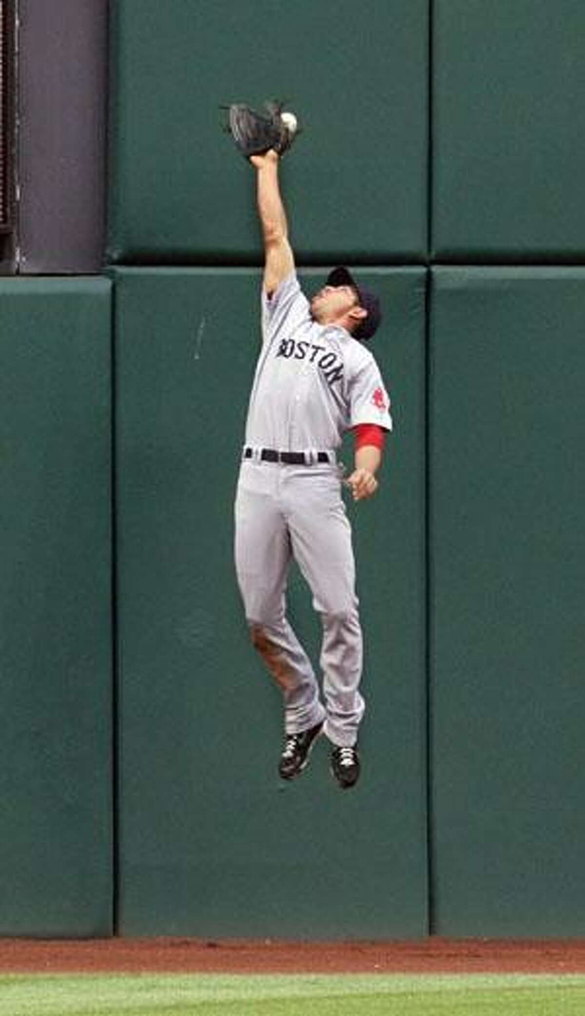 Boston Red Sox outfielder Jacoby Ellsbury jumps for a ball hit by Cleveland Indians' Victor Martinez during the first inning Wednesday in Cleveland. Martinez tripled and Asdrubal Cabrera scored on the play.