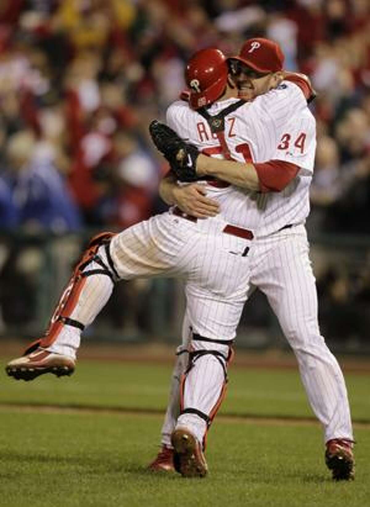 Philadelphia Phillies starting pitcher Roy Halladay celebrates with catcher Carlos Ruiz (51) after throwing a no-hitter to defeat the Cincinnati Reds 4-0 during Game 1 of baseball's National League Division Series Wednesday, Oct. 6, 2010, in Philadelphia. (AP Photo/Rob Carr)