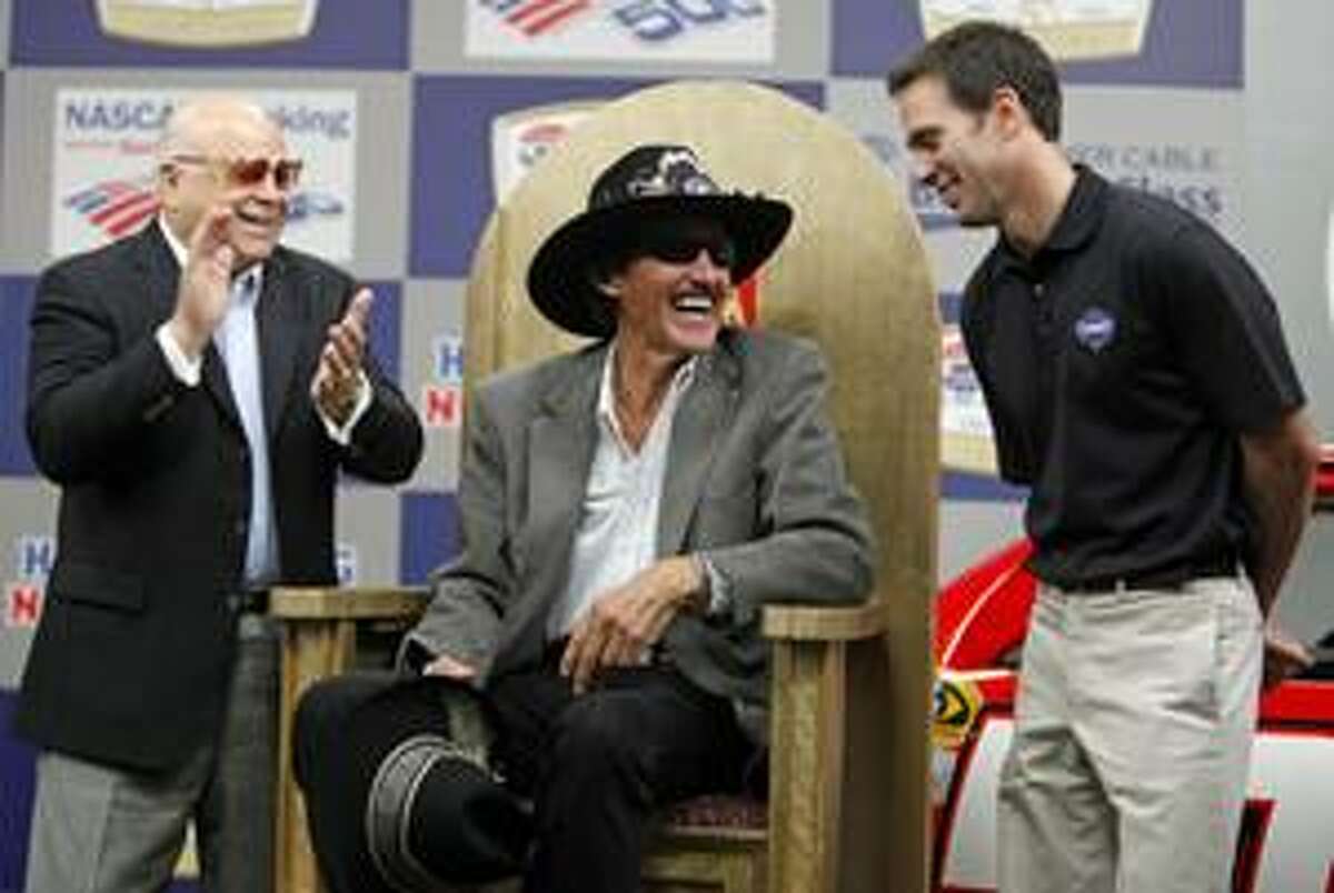 AP NASCAR legend Richard Petty, center, shares a laugh with defending NASCAR Sprint Cup champion Jimmie Johnson, right, and Lowe's Motor Speedway owner Bruton Smith, left, during a news conference at the race track in Concord, N.C., Wednesday. The Banking 500 auto race will be run Sunday.