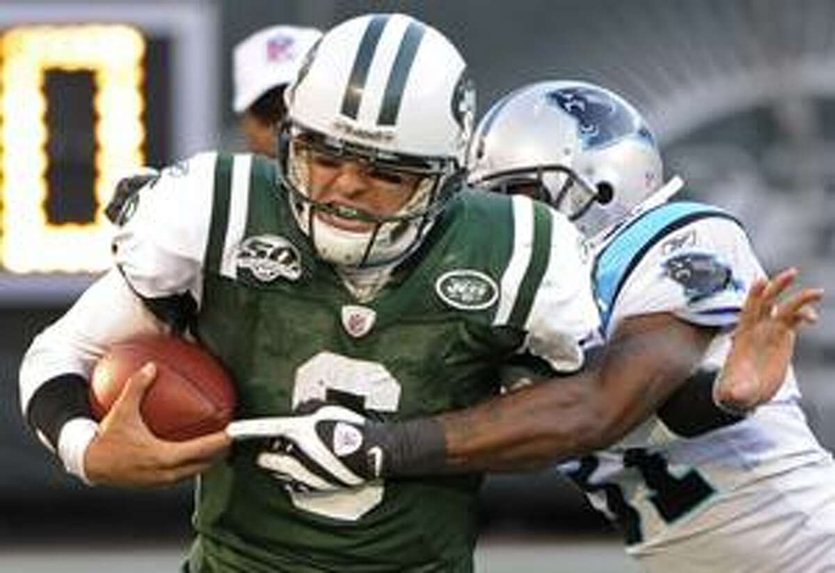 New York Jets quarterback Mark Sanchez (6) is tackled by Carolina Panthers cornerback Richard Marshall (31) during the third quarter Sunday in East Rutherford, N.J.