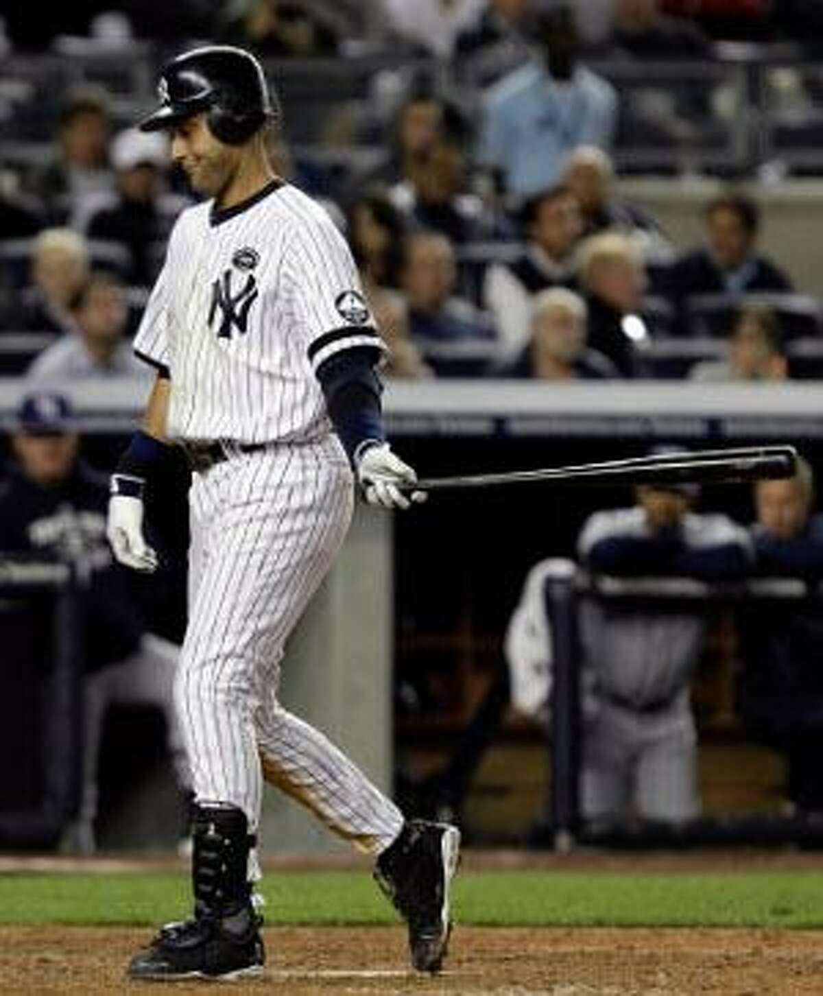 New York Yankees Derek Jeter looks at his bat before stepping into