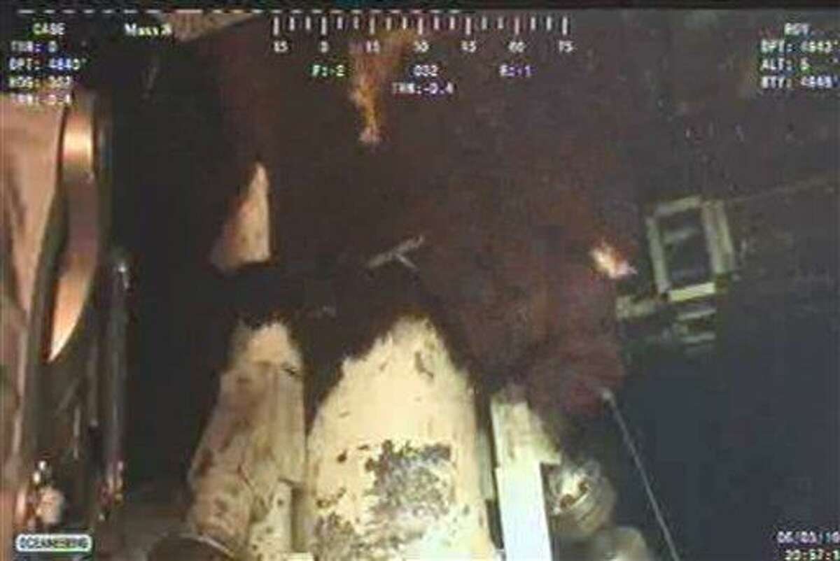 This image taken from video released by BP LLC shows oil gushing during efforts to cap the Deepwater Horizon oil well in the Gulf of Mexico, Thursday, June 3, 2010. (AP Photo/BP LLC) NO SALES