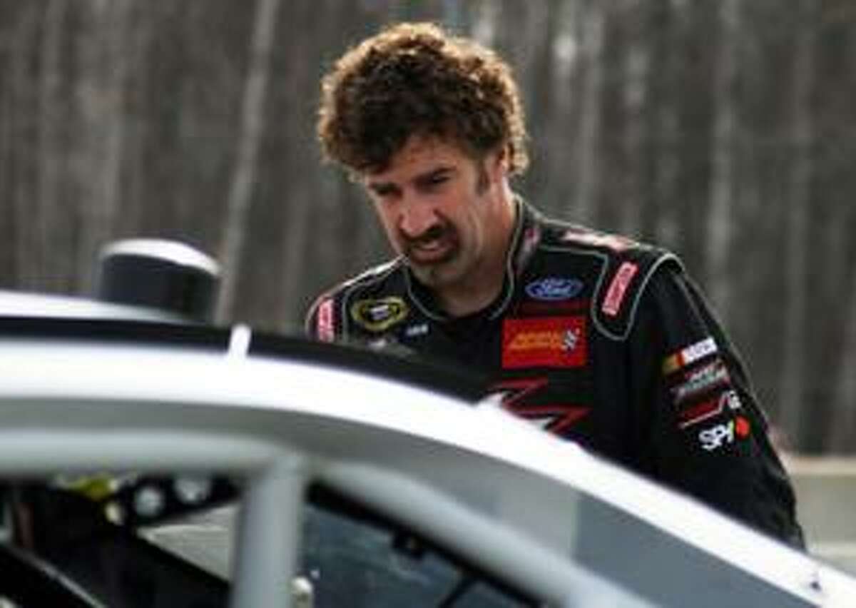 Boris Said prepares to climb into his car for a test session at Road America in Elkhart Lake, Wis. on Wednesday, March 24, 2010. The track, which is set in the woods of central Wisconsin, will host a NASCAR Nationwide Series auto race June 19. (AP Photo/Chris Jenkins)