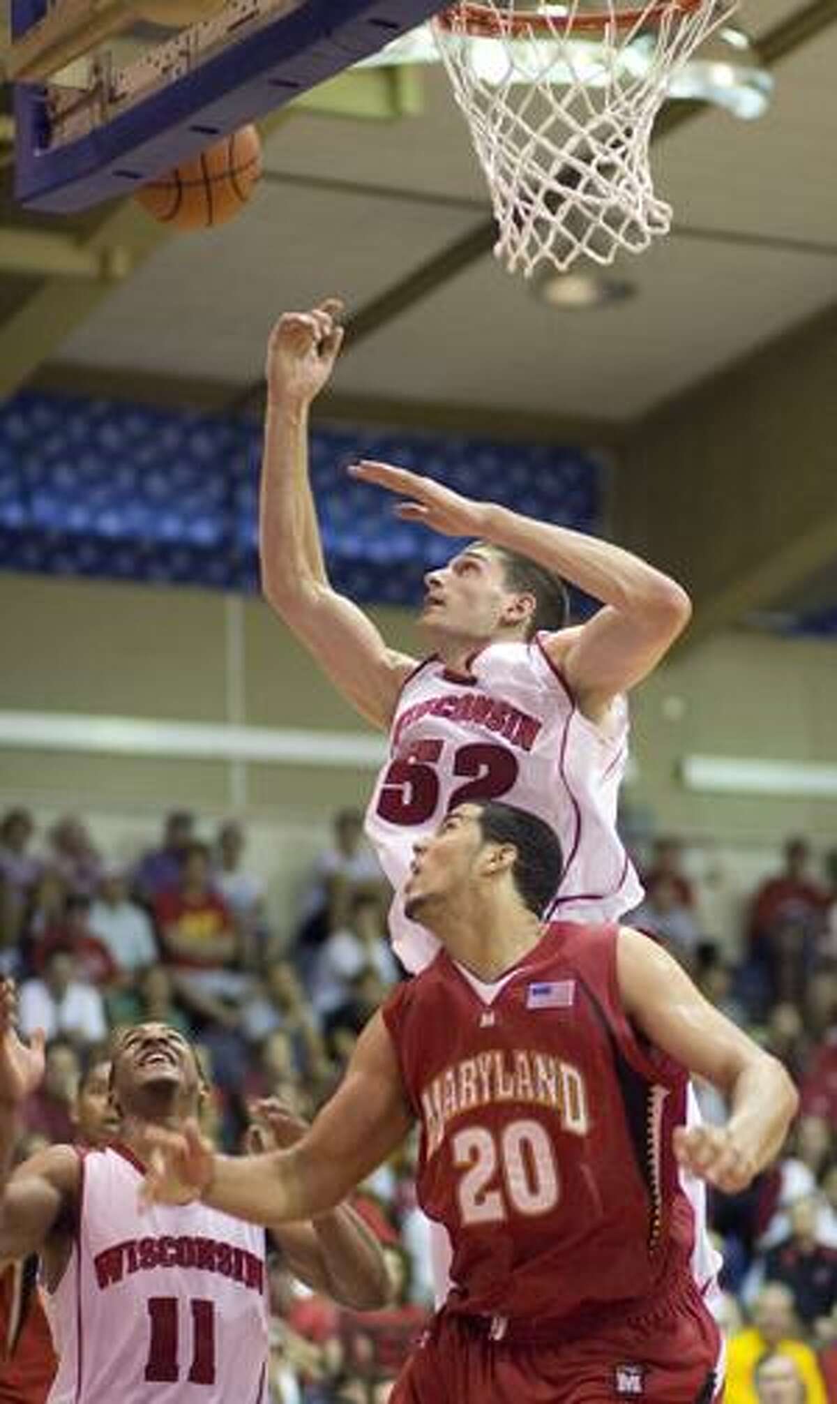 AP Wisconsin guard Jordan Taylor (11) looks on as teammate Keaton Nankivil (52) looks to grab a rebound over Maryland's Jordan Williams (20) in the second half of an NCAA college basketball game Wednesday at the Maui Invitational in Lahaina, Hawaii.