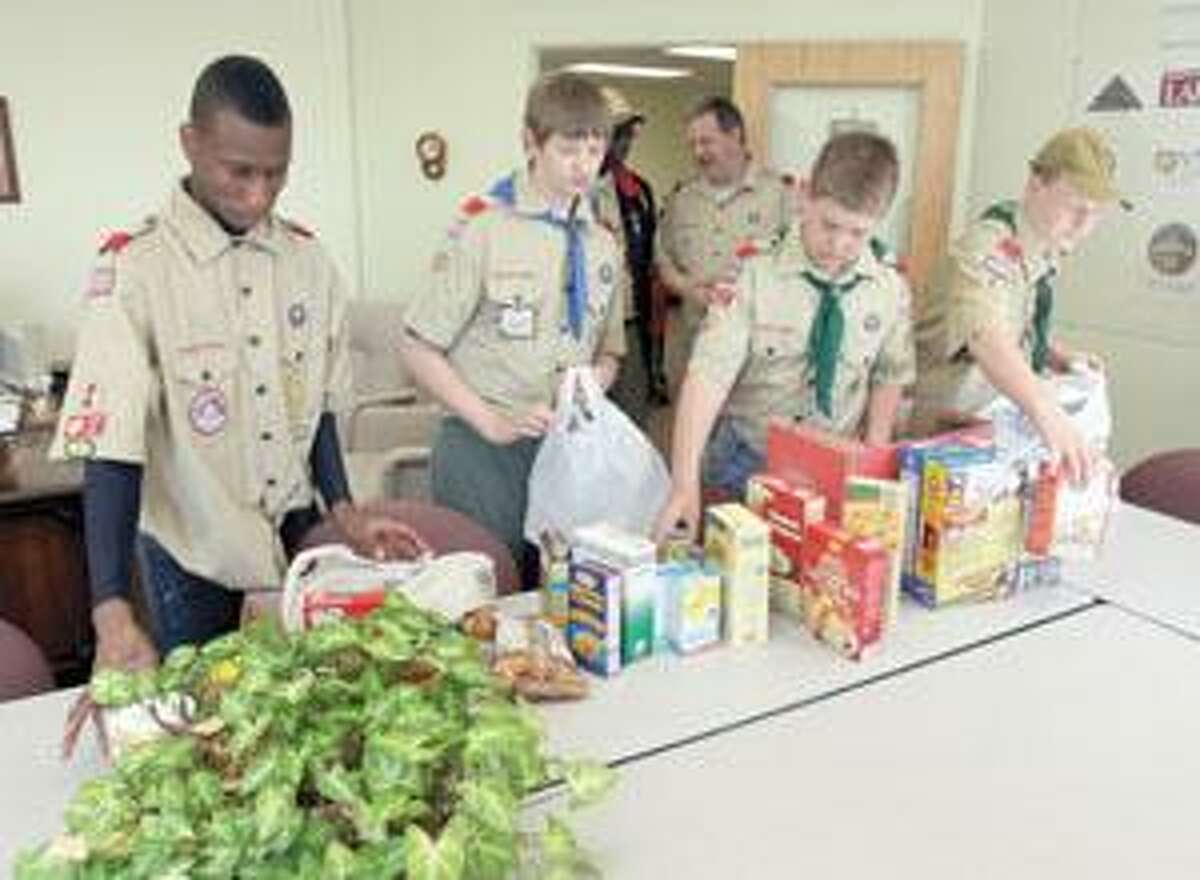 New scouts receive uniforms, donate food