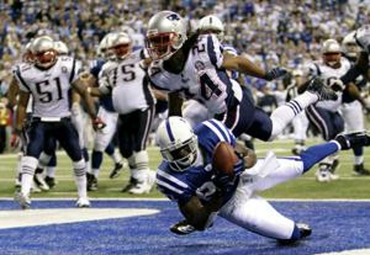 Indianapolis Colts wide receiver Reggie Wayne (87) is hit by New