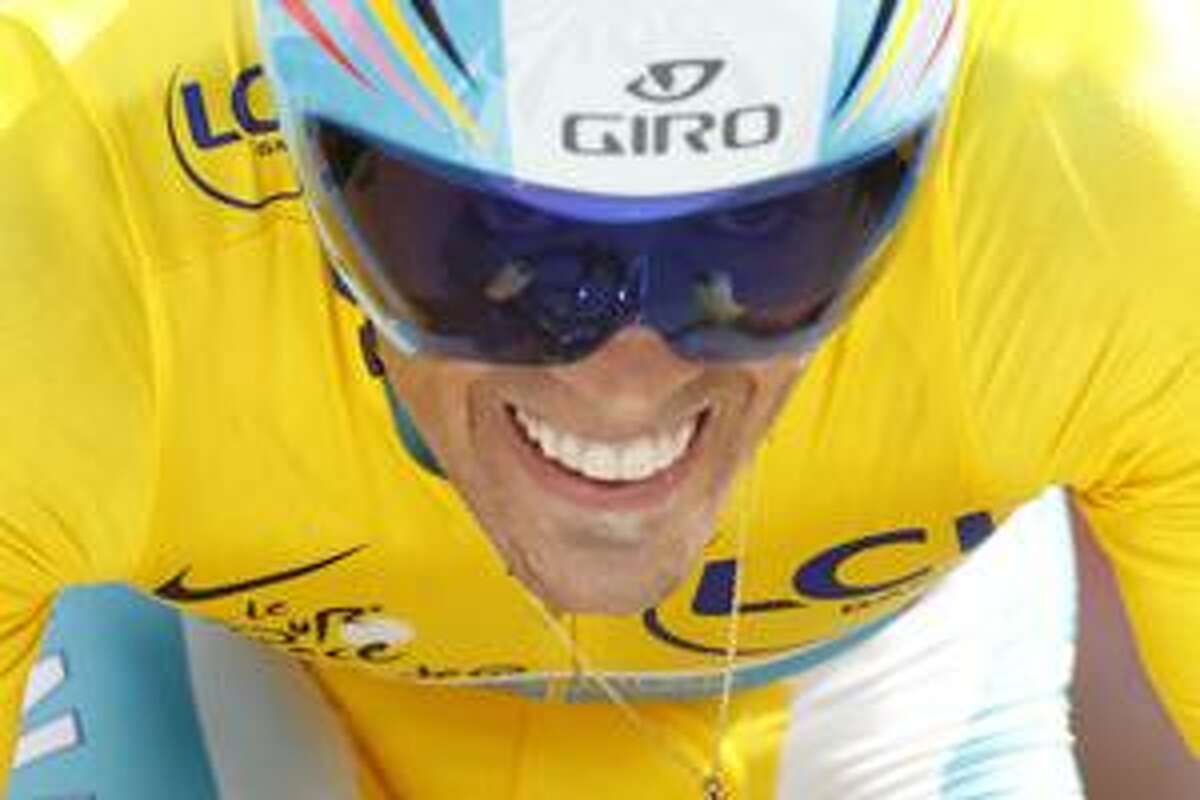 Alberto Contador of Spain, wearing the overall leader's yellow jersey, strains during the 19th stage of the Tour de France cycling race, an individual time trial over 52 kilometers (32.3 miles) with start in Bordeaux and finish in Pauillac, south western France, Saturday, July 24, 2010. (AP Photo/Laurent Rebours)
