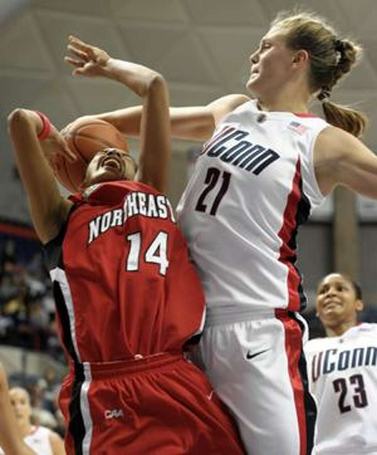 Connecticut's Heather Buck, right, fouls Northeastern's Brittany Wilson during the first half Saturday in Storrs. The Huskies travel to San Antonio to play Texas tonight.