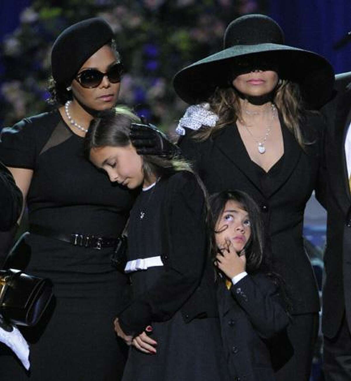 Singer Janet Jackson, left, Paris Katherine Jackson, Prince Michael Jackson II, and LaToya Jackson are seen on stage during the memorial service for Michael Jackson at the Staples Center in Los Angeles, Tuesday, July 7, 2009. (AP Photo/Mark J. Terrill, Pool)