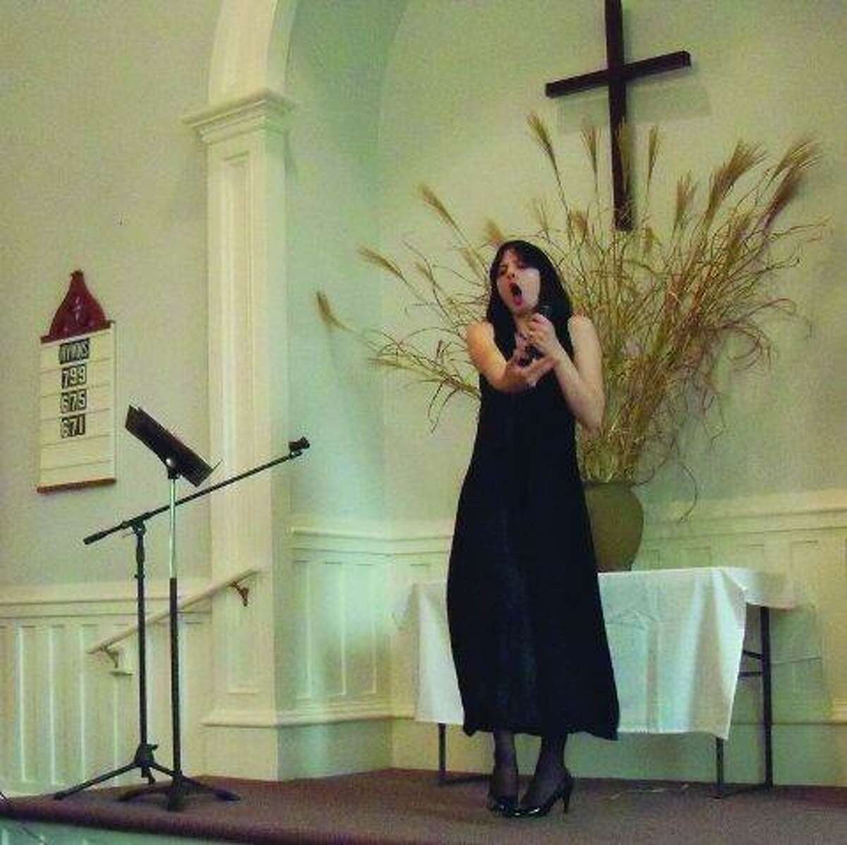 JASON SIEDZIK/ Register Citizen Heather Blauvelt, a Torrington native, sings "Get Me To the Church On Time" during her solo performance at Torrington's First Congregational Church, "A Touch of Class - Music for the Soul". The song was one of three from My Fair Lady, and the show -- which featured duets with Blauvelt's 7-year-old daughter, Angel, and Blauvelt's grandmother, Diane Kirsch, blended secular and spiritual songs.