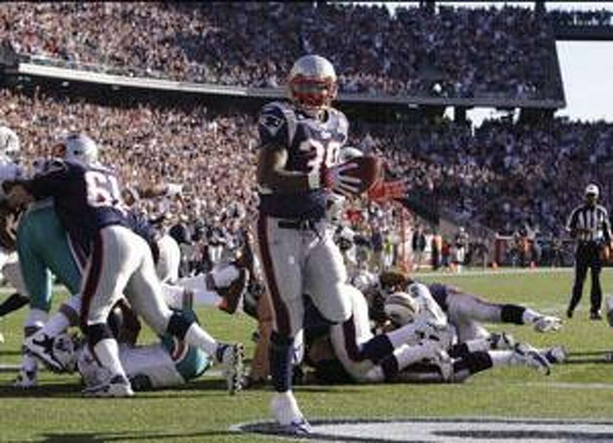 New England Patriots running back Laurence Maroney (39) runs into the end zone for a touchdown during the first quarter against the Miami Dolphins Sunday in Foxboro, Mass.