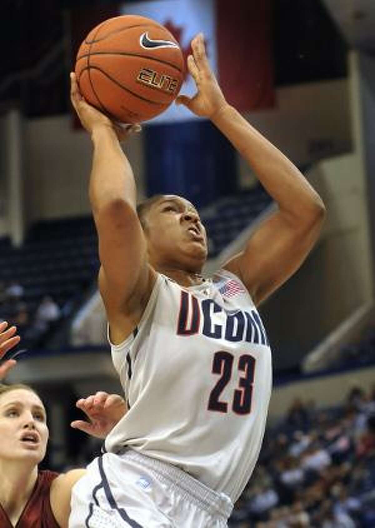 AP Connecticut's Maya Moore drives to the basket while guarded by Indiana of Pennsylvania's Brianna Johnson during the first half of a Nov. 10 exhibition game in Hartford. All-American Moore and her two-time defending champion Huskies teammates enter Sunday's season opener against Holy Cross with a record 78-game winning streak.