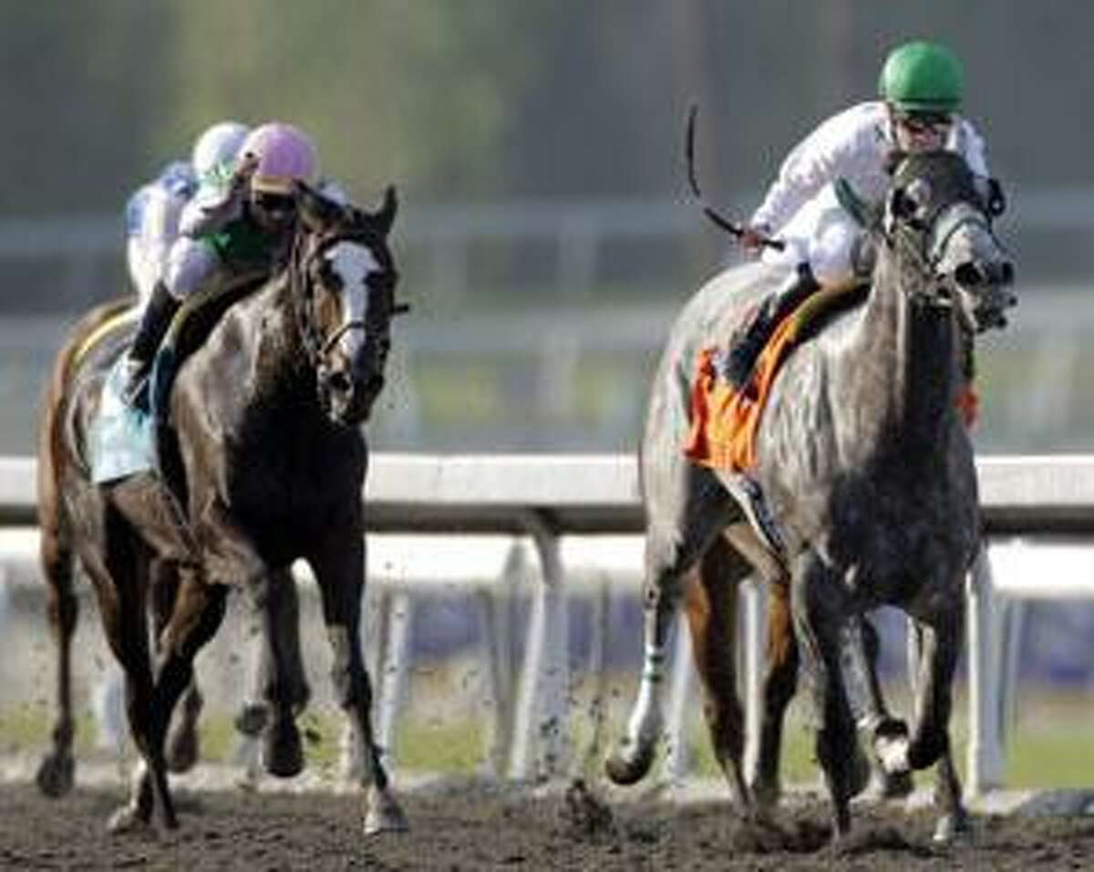 AP Jockey Julien Leparoux, right, on Informed Decision, leads Ventura, ridden by Garret Gomez, left, during the Breeders' Cup Filly & Mare Sprint horse race at Santa Anita Park Friday in Arcadia, Calif. Informed Decision won the race and Ventura took second.