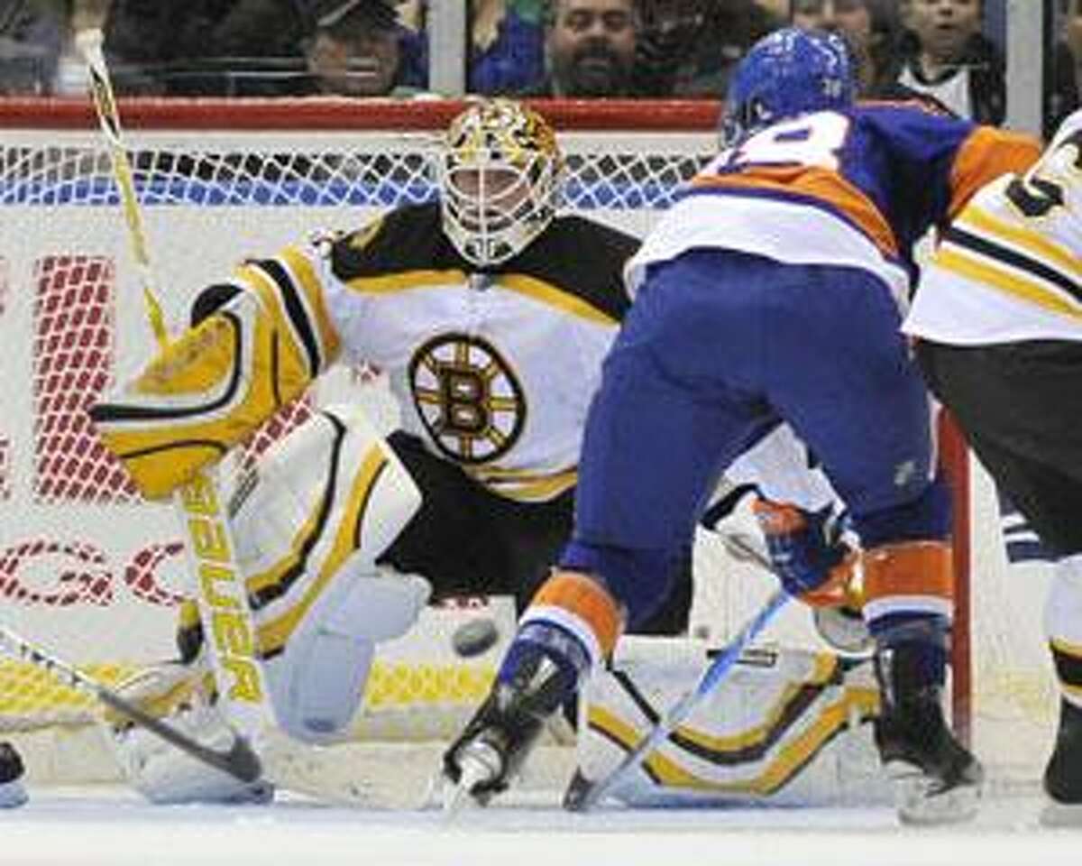 Boston Bruins goalie Tim Thomas blocks shot at goal by New York Islanders' Jack Hillen (38) during the third period of an NHL hockey game Saturday, March 6, 2010, in Uniondale, N.Y. The Bruins defeated the Islanders 3-2. (AP Photo/Kathy Kmonicek)